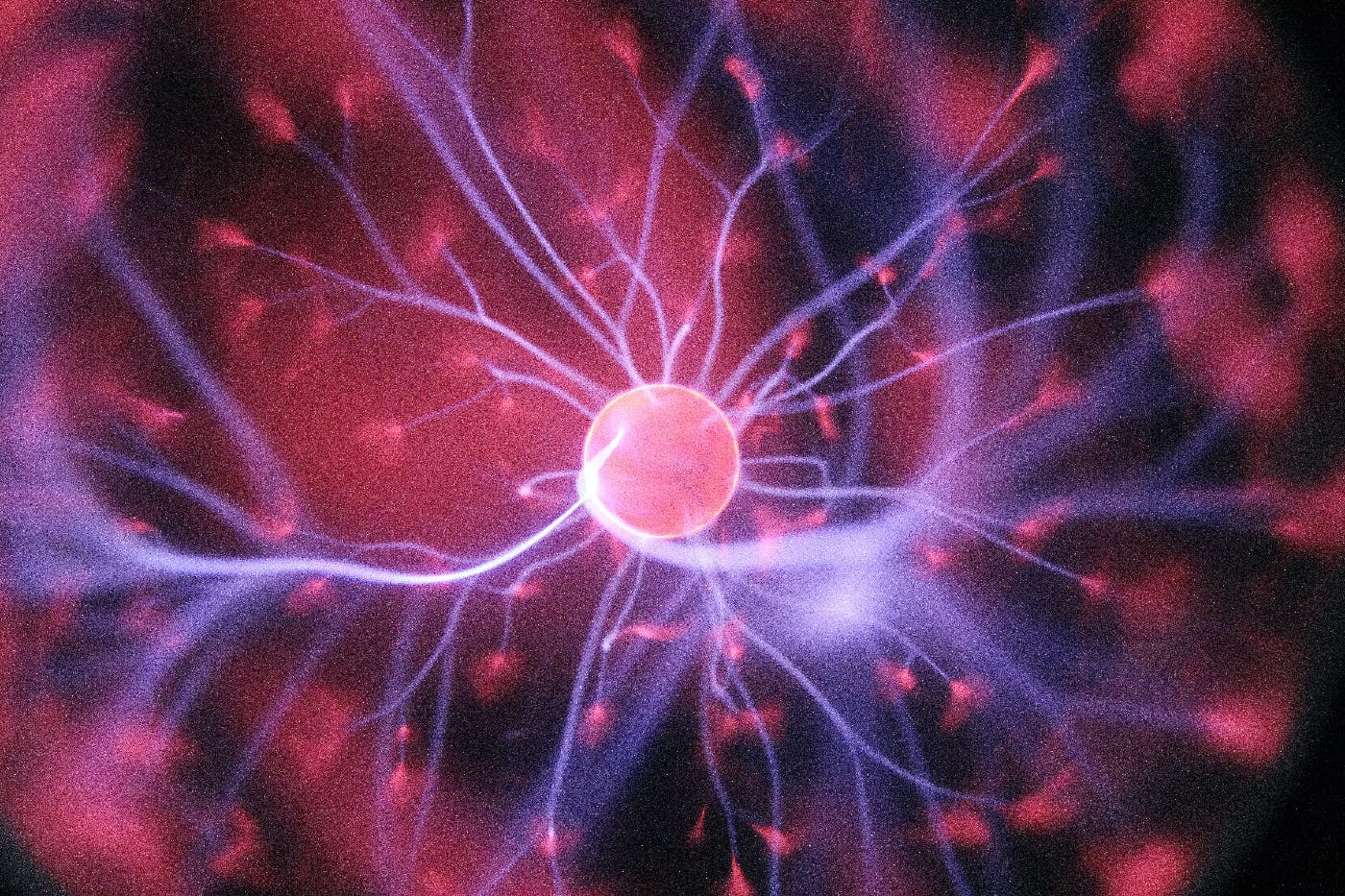 a red, purple and pink plasma ball