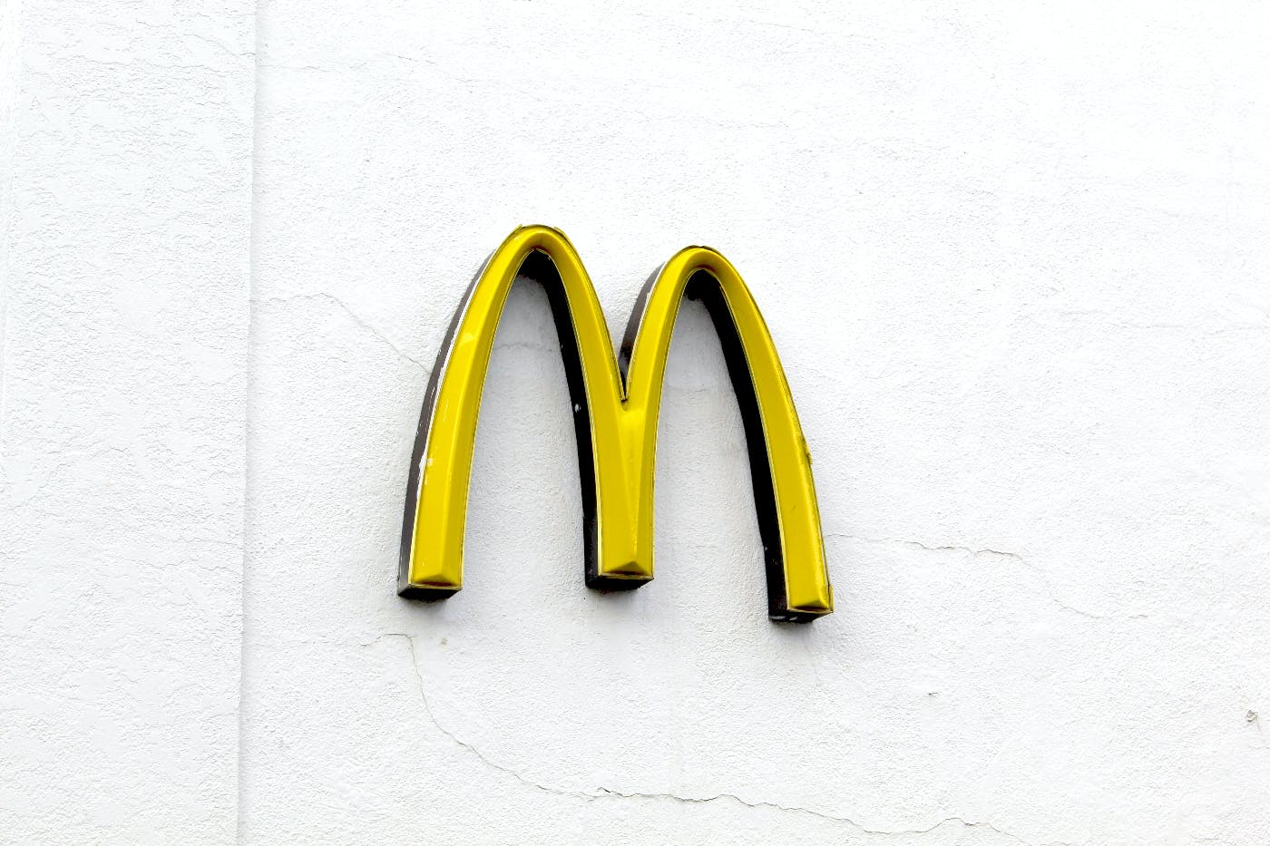McDonald's golden arches on a white wall