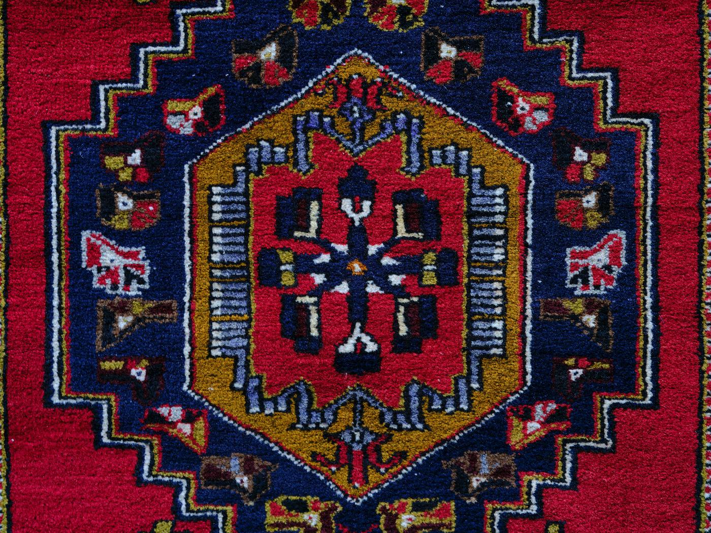 a colorful woven rug with a center design