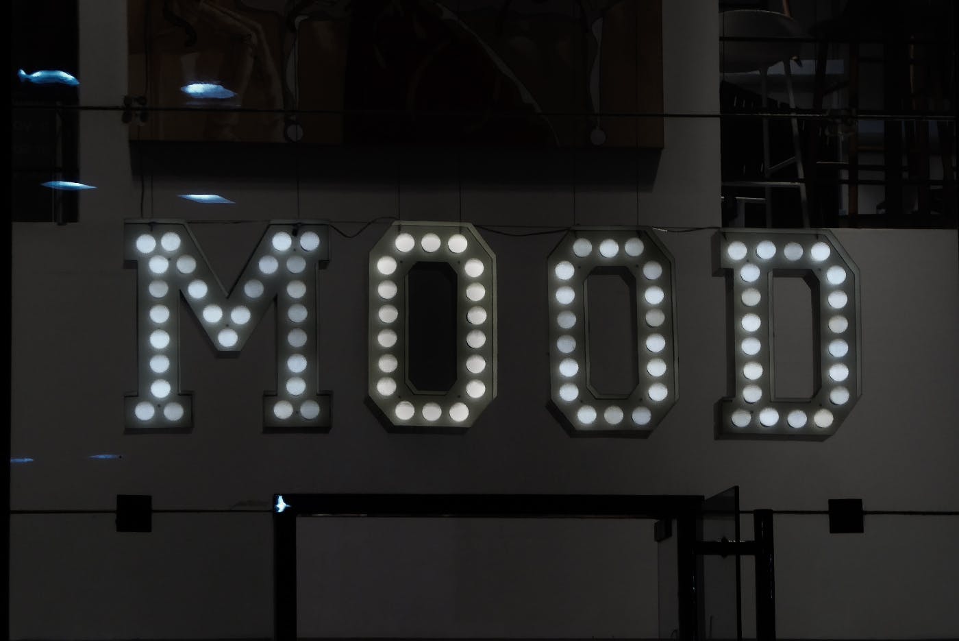 The word Mood on a wall with lights on the letters
