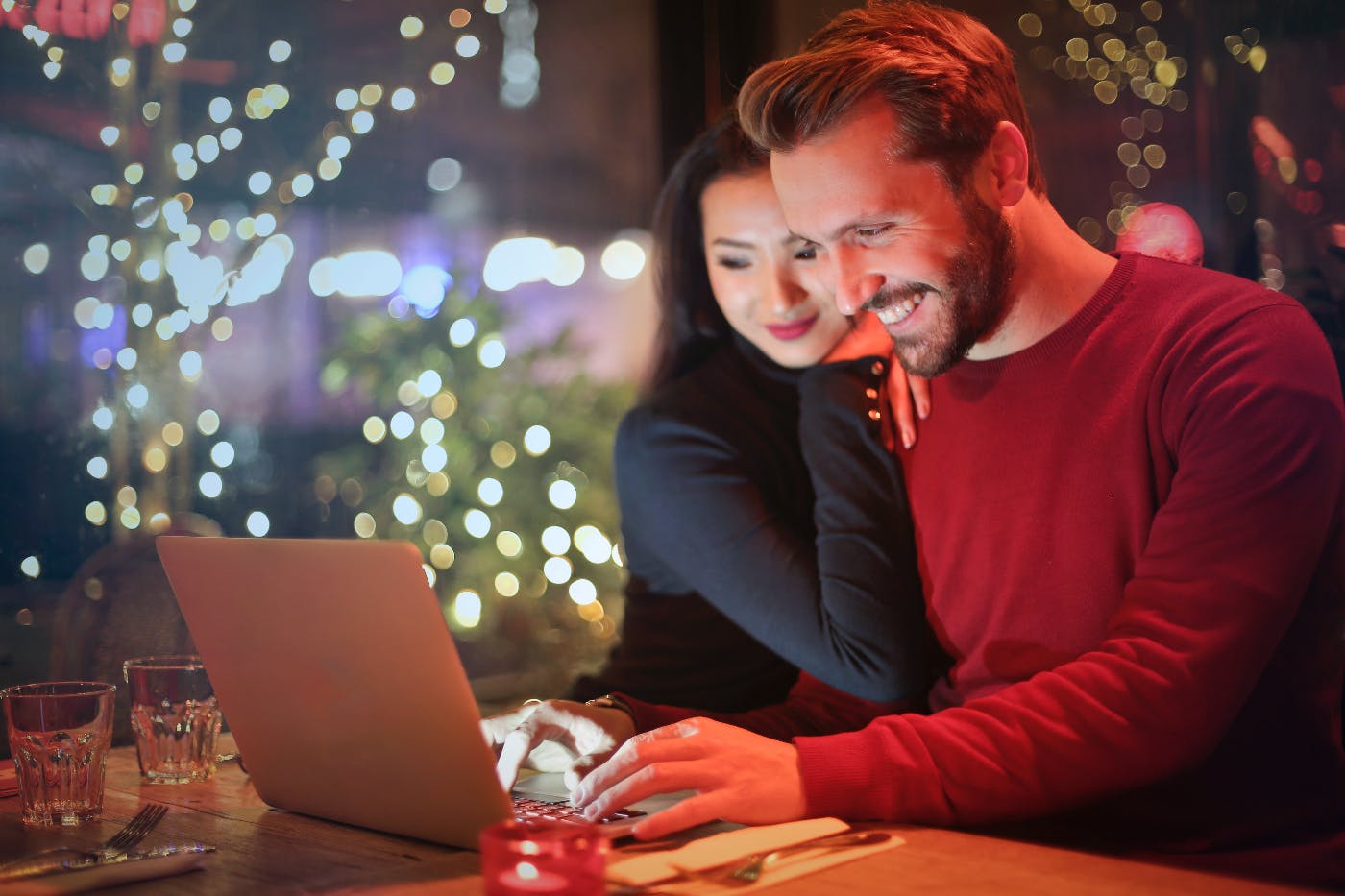 A young couple snuggling looking at a laptop