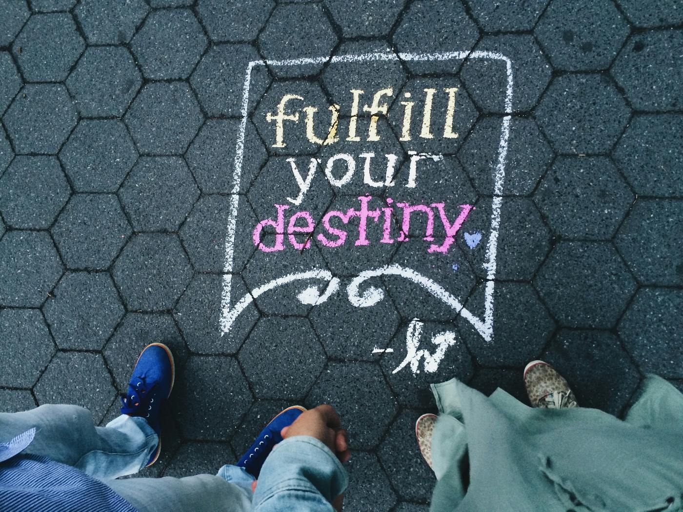 Chalk on a sidewalk reading: Fulfill your destiny
