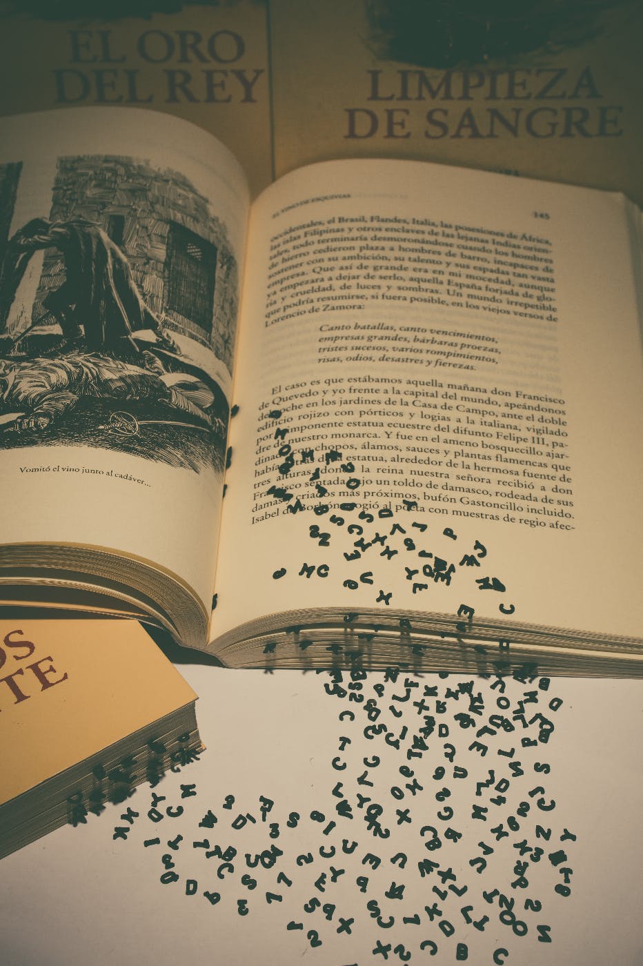 An open book with letters pouring off the page
