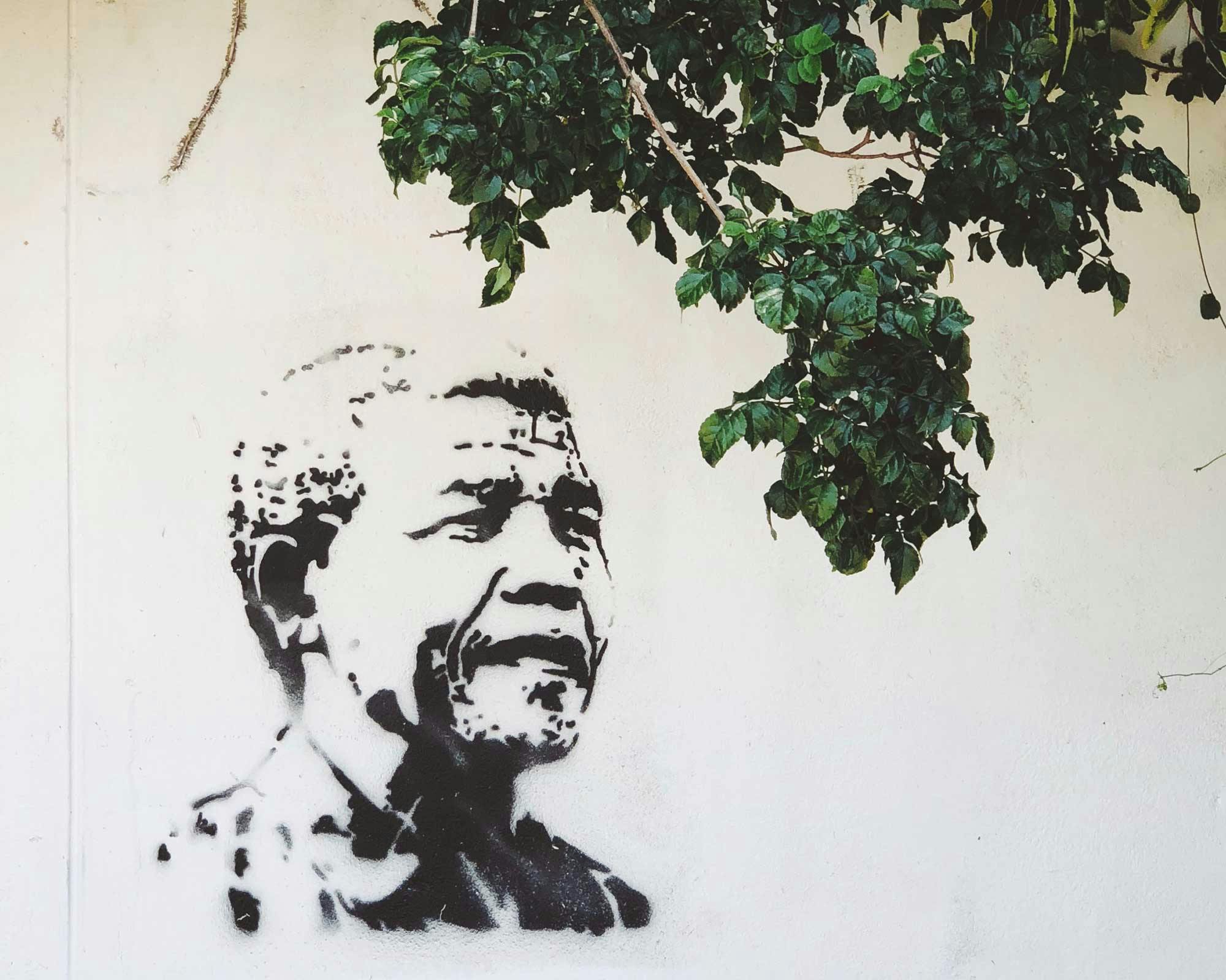 A street art painting of Nelson Mandela on a wall