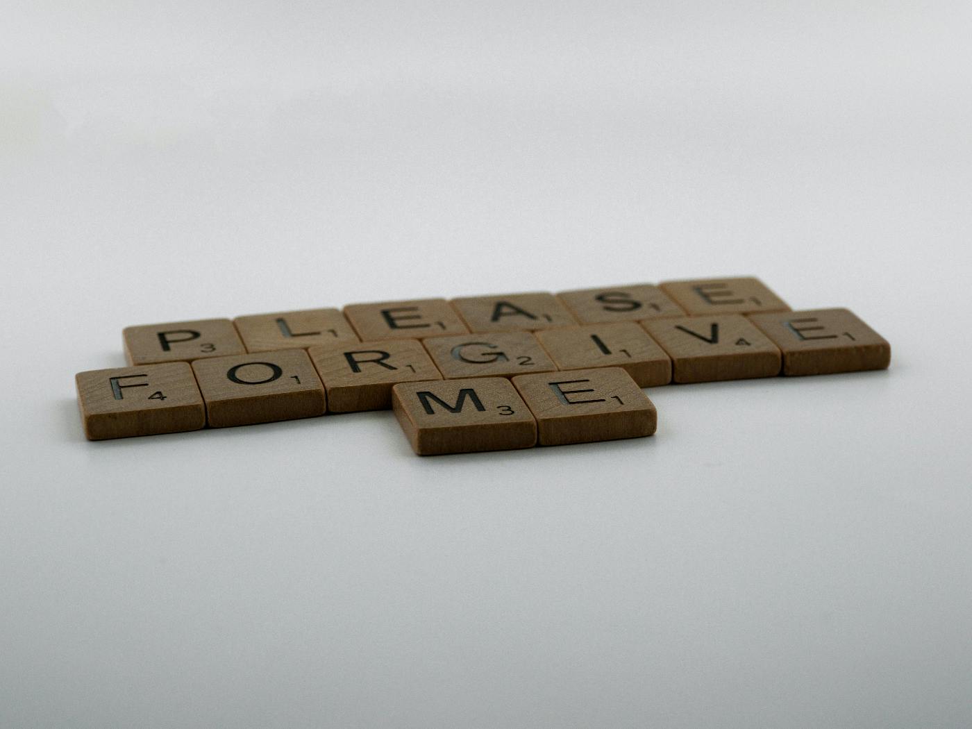 Scrabble tiles spelling out, please forgive me