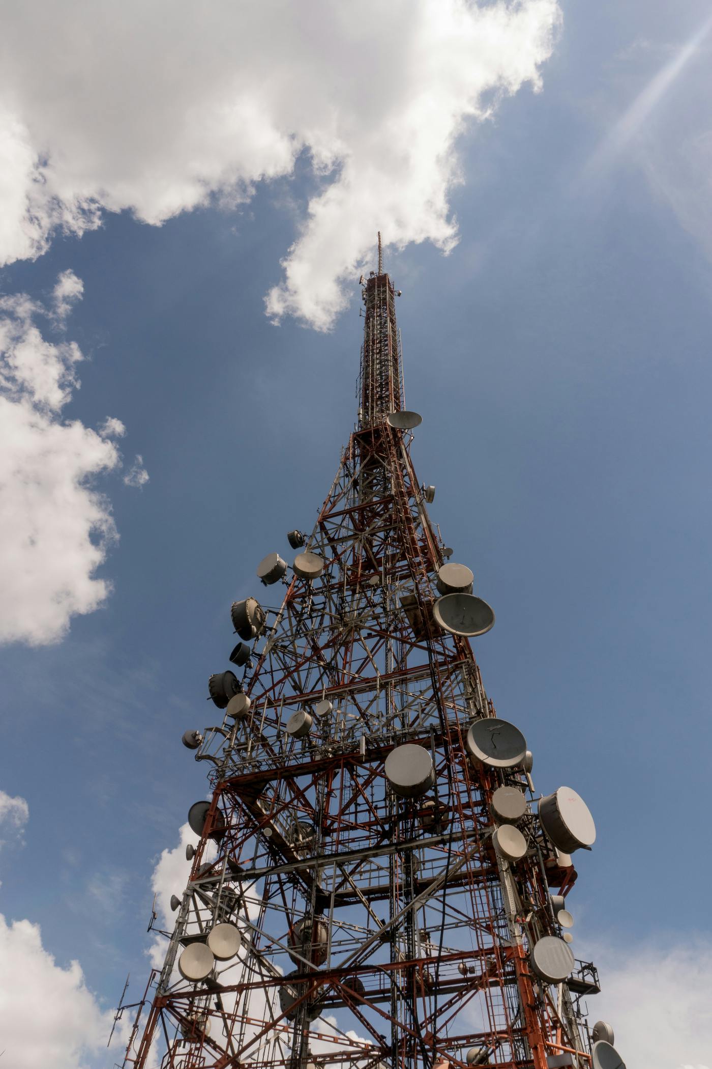 A large wireless tower against a blue sky