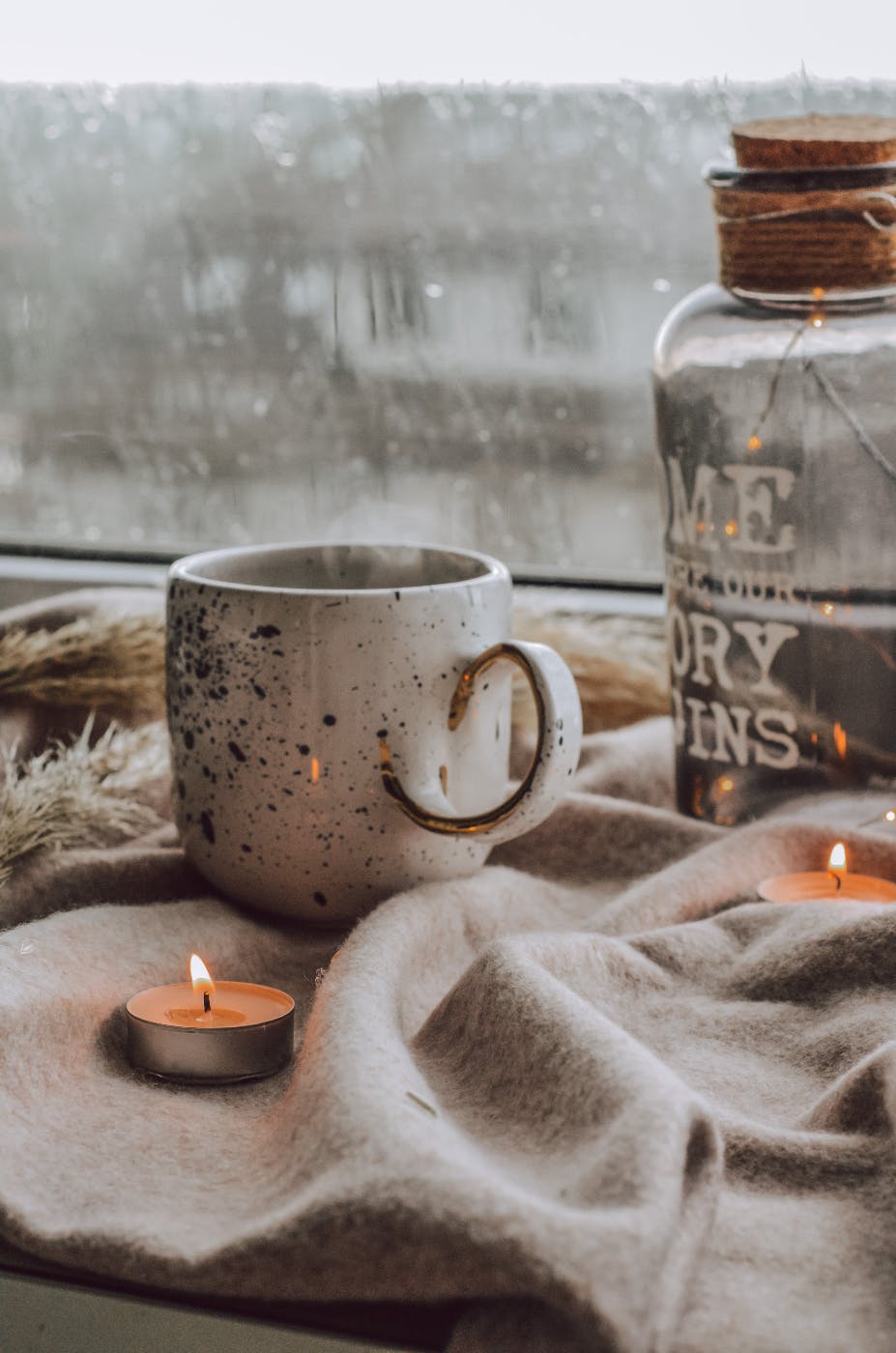 a coffee cup and some candles