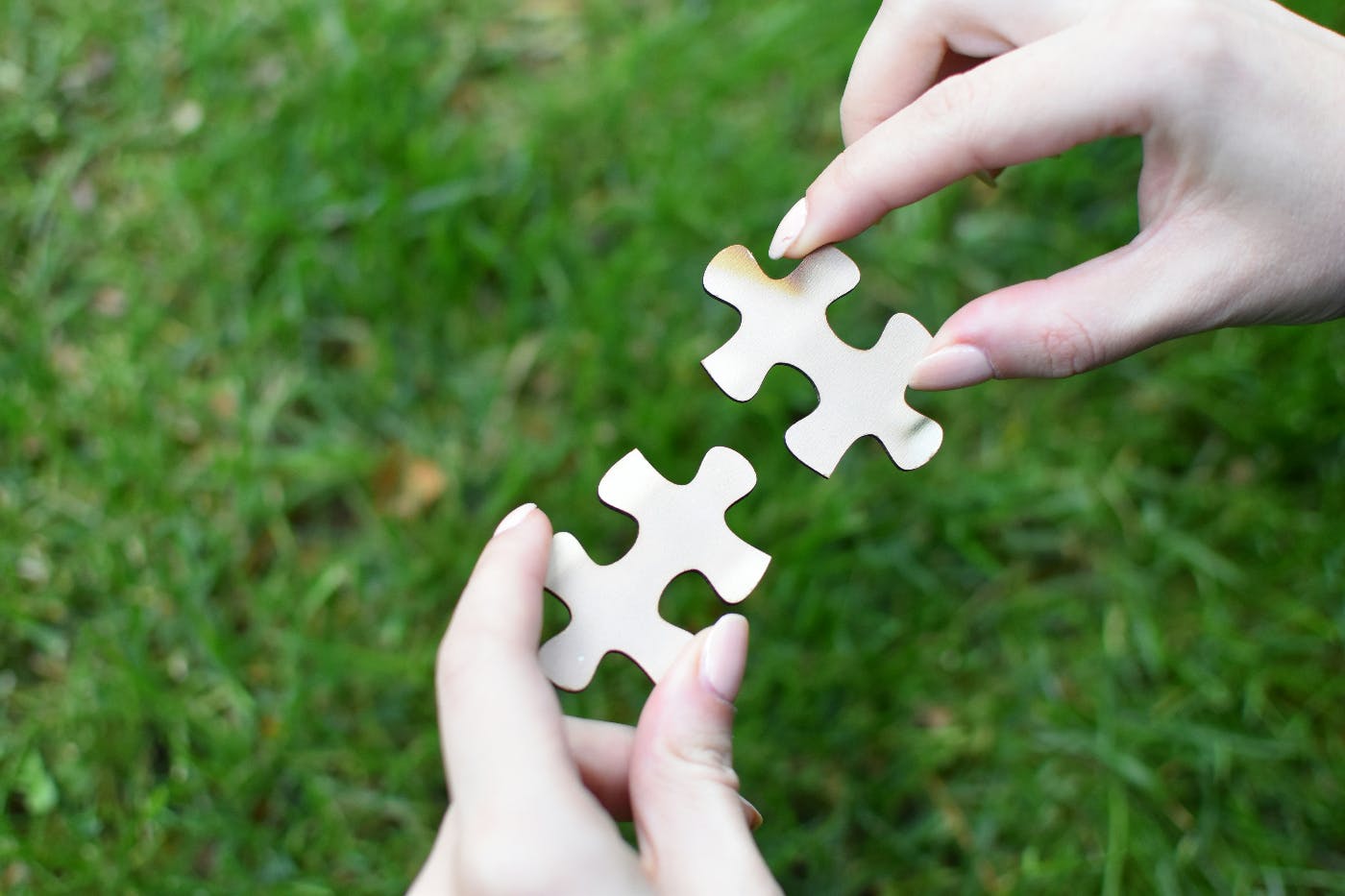 A woman's hands holding two puzzle pieces that obviously go together