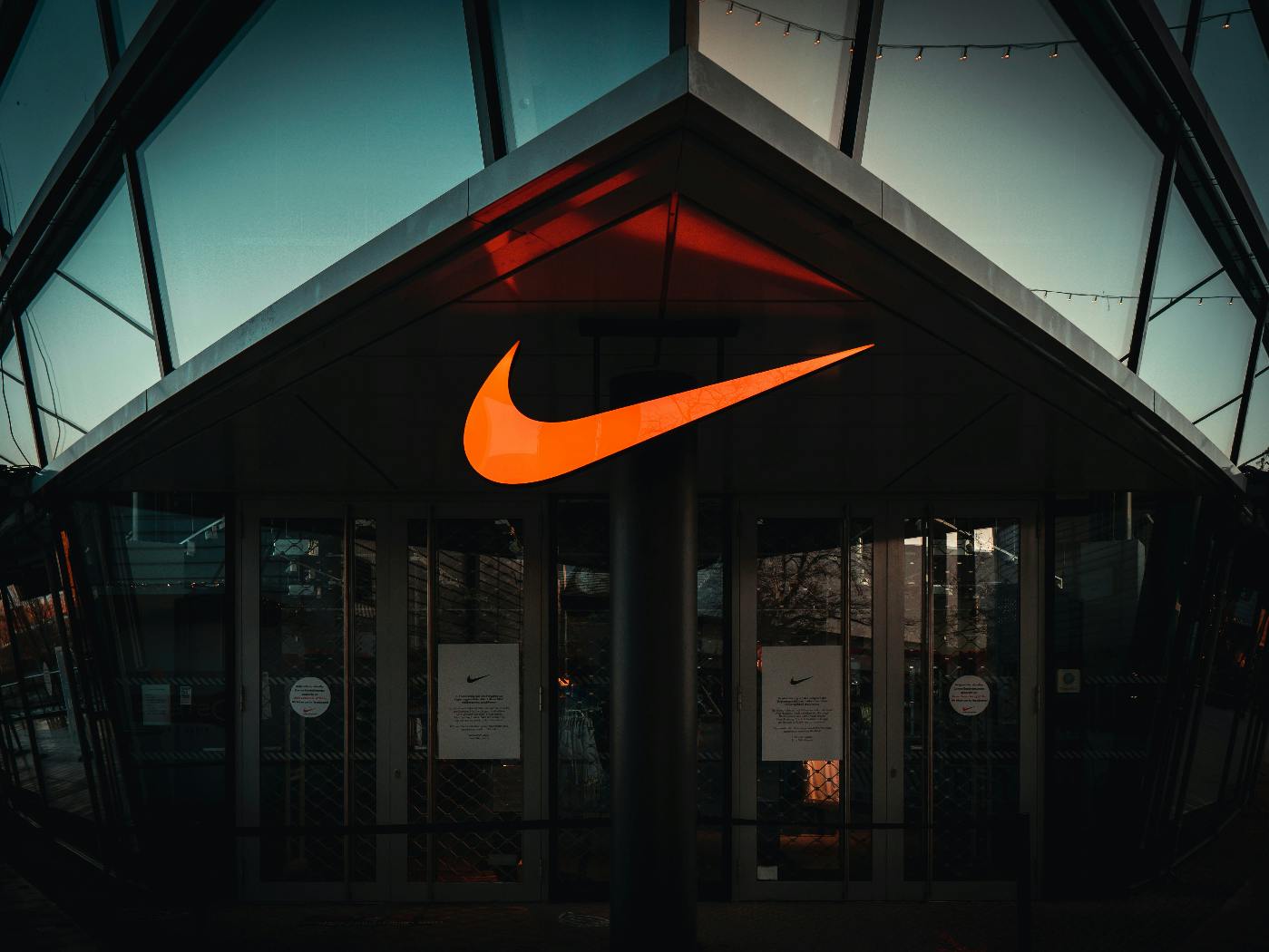A buildoing with a giant Nike swoosh over the entrance