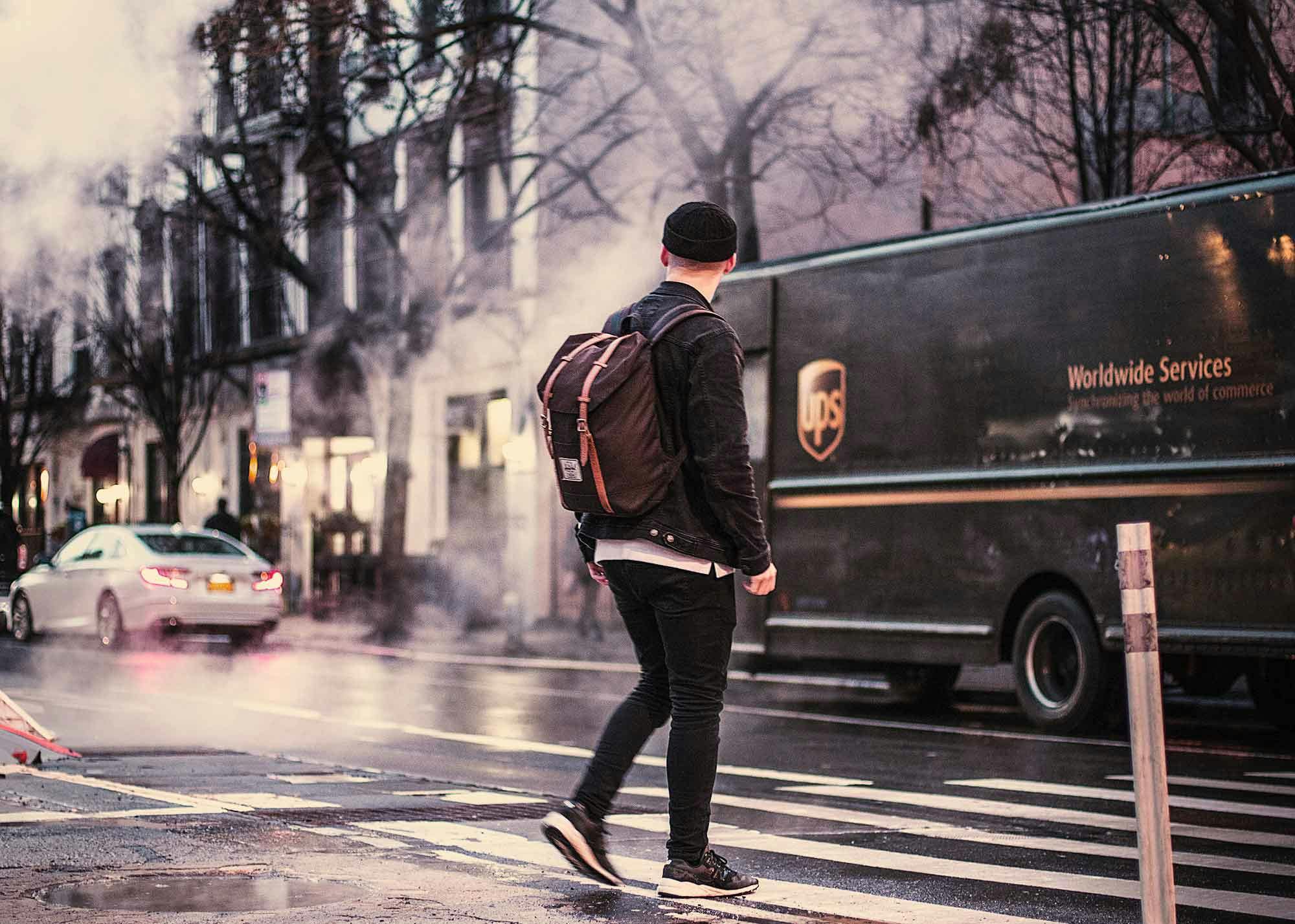 Man walking into the road with a UPS truck nearby