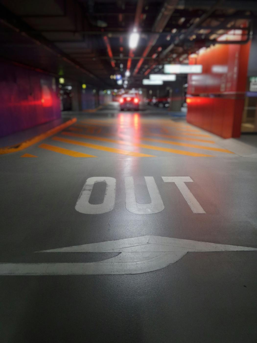 A parking garage with OUT painted on the floor