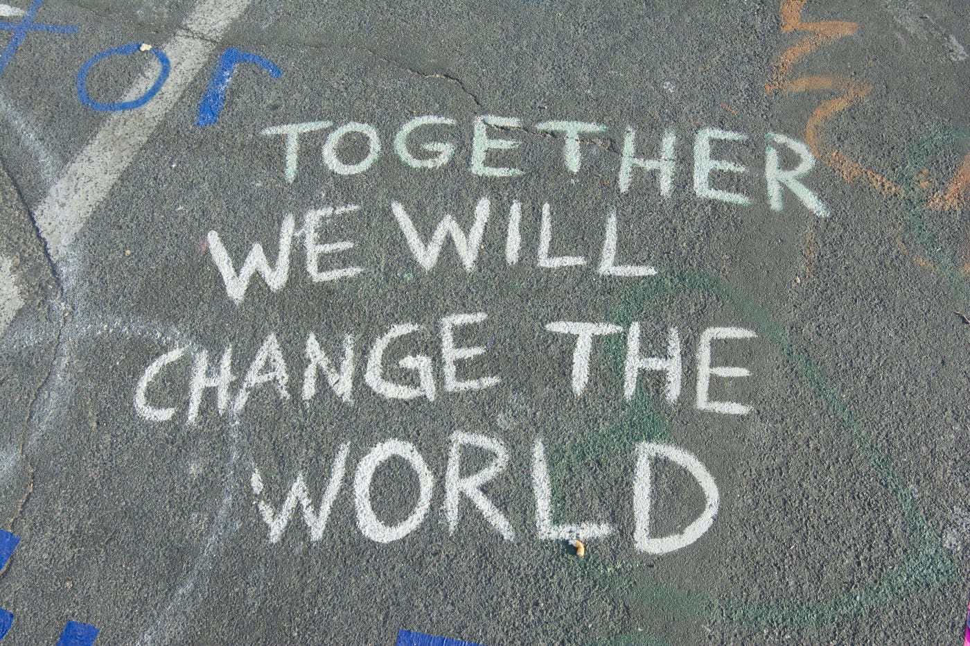 Sidewalk chalked with Together We Will Chnage the World