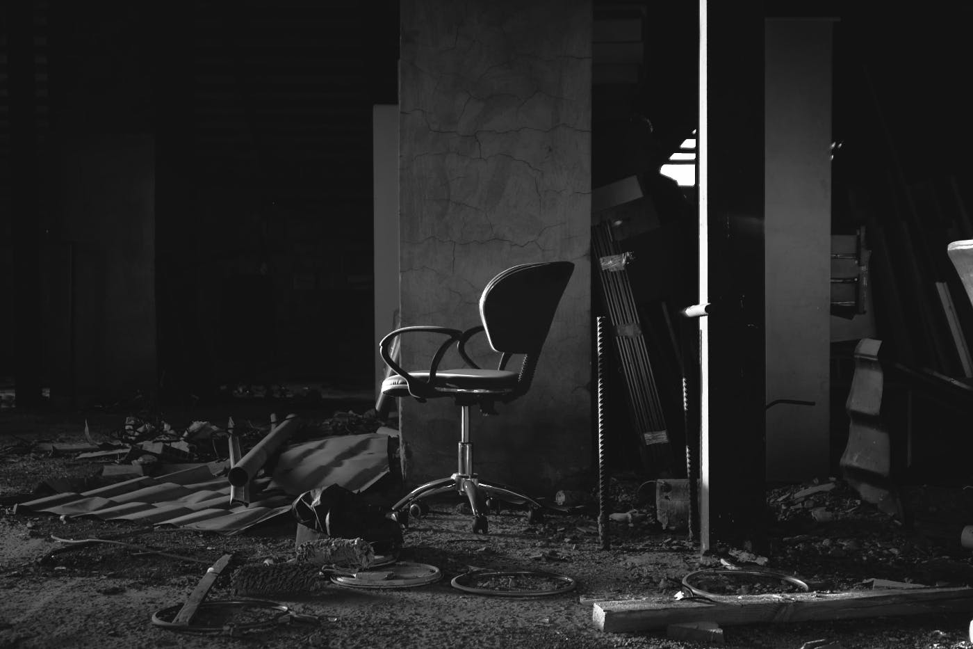 a clean desk chair in the midst of a destroyed office.