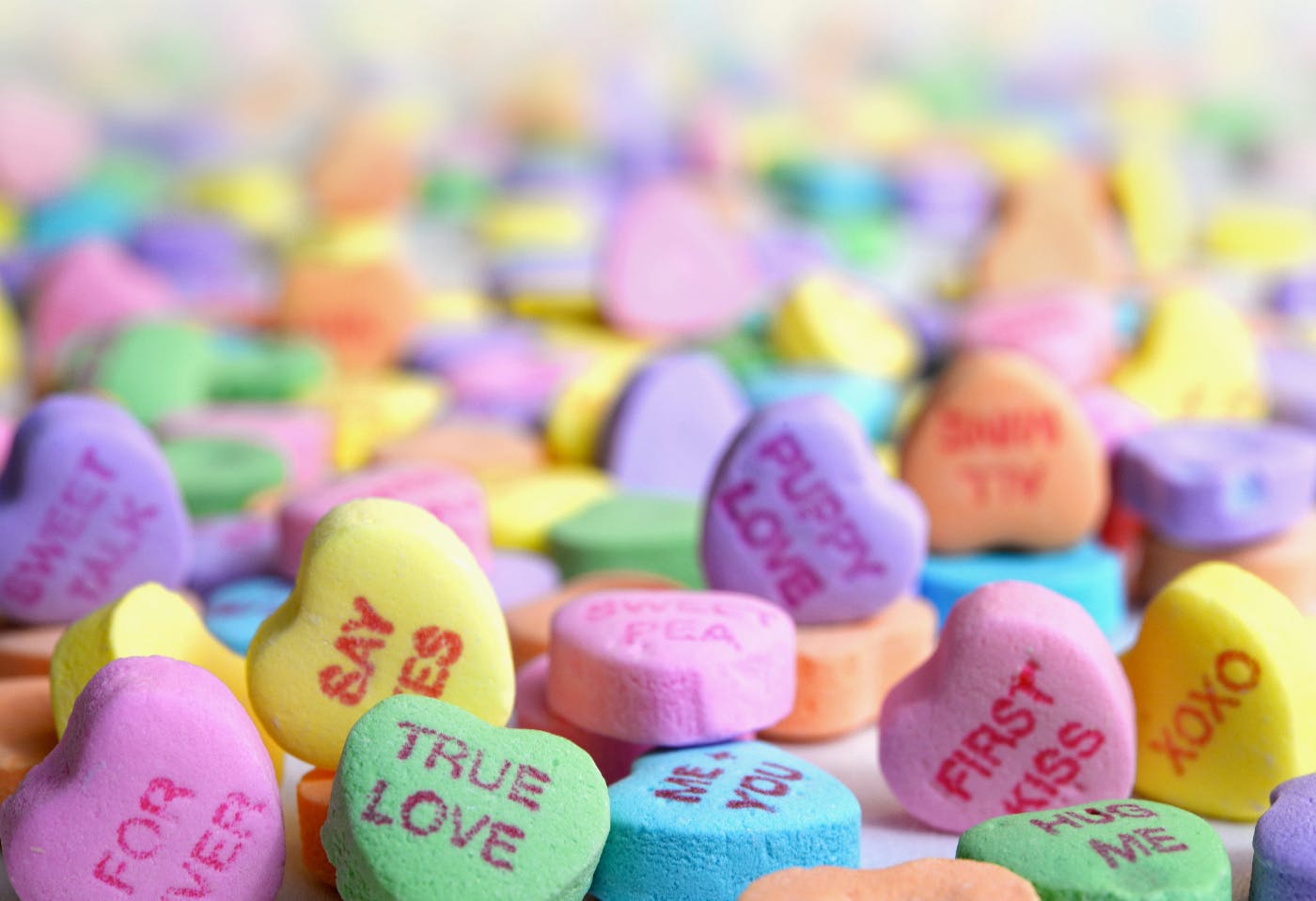 An endless pile of tiny colored hearts with messages on them