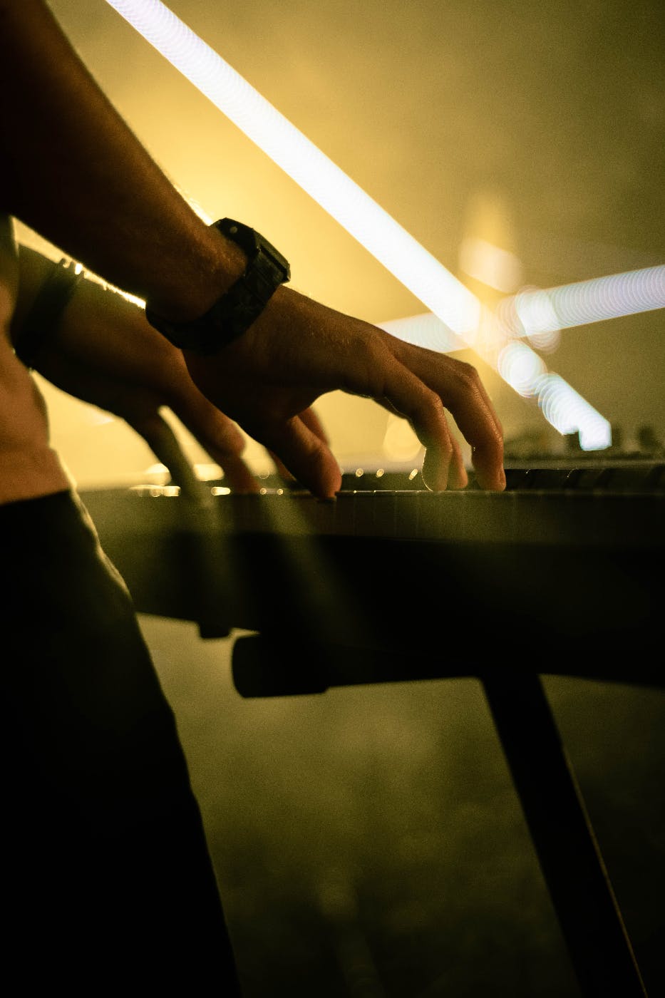 hands on a piano keyboard