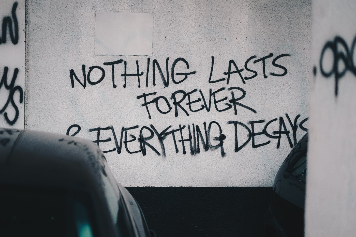 A wall spray painted with Nothing Lasts Forever Everything Decays