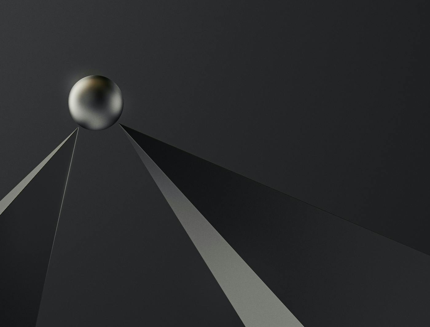 a steel ball sitting atop two steel spikes