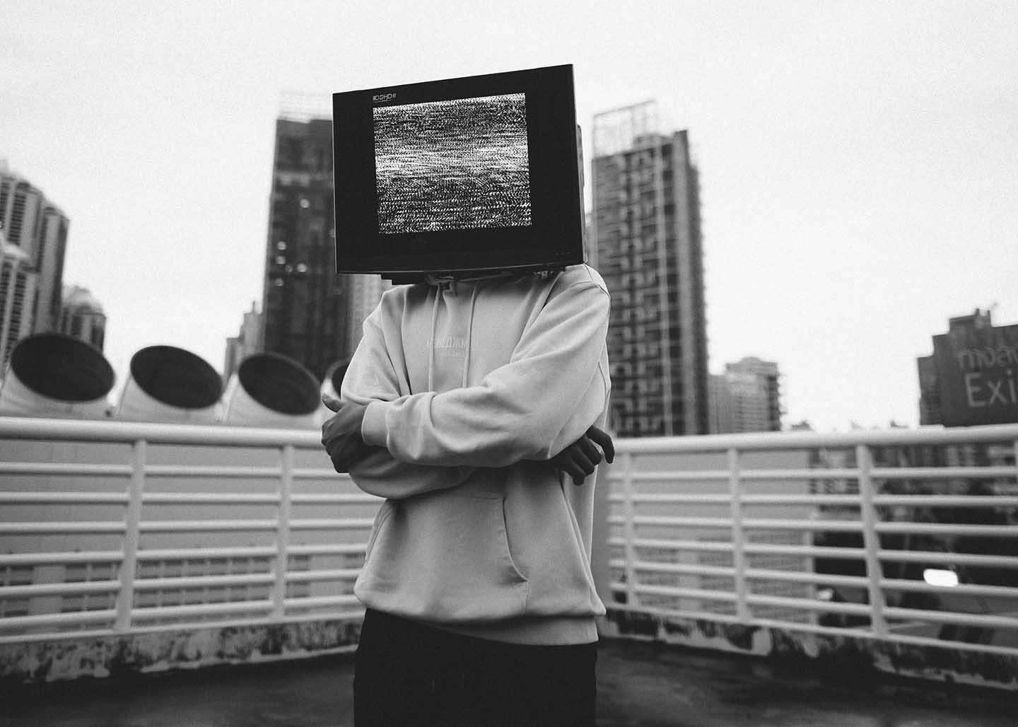 Man on the rooftop with a TV where his head should be