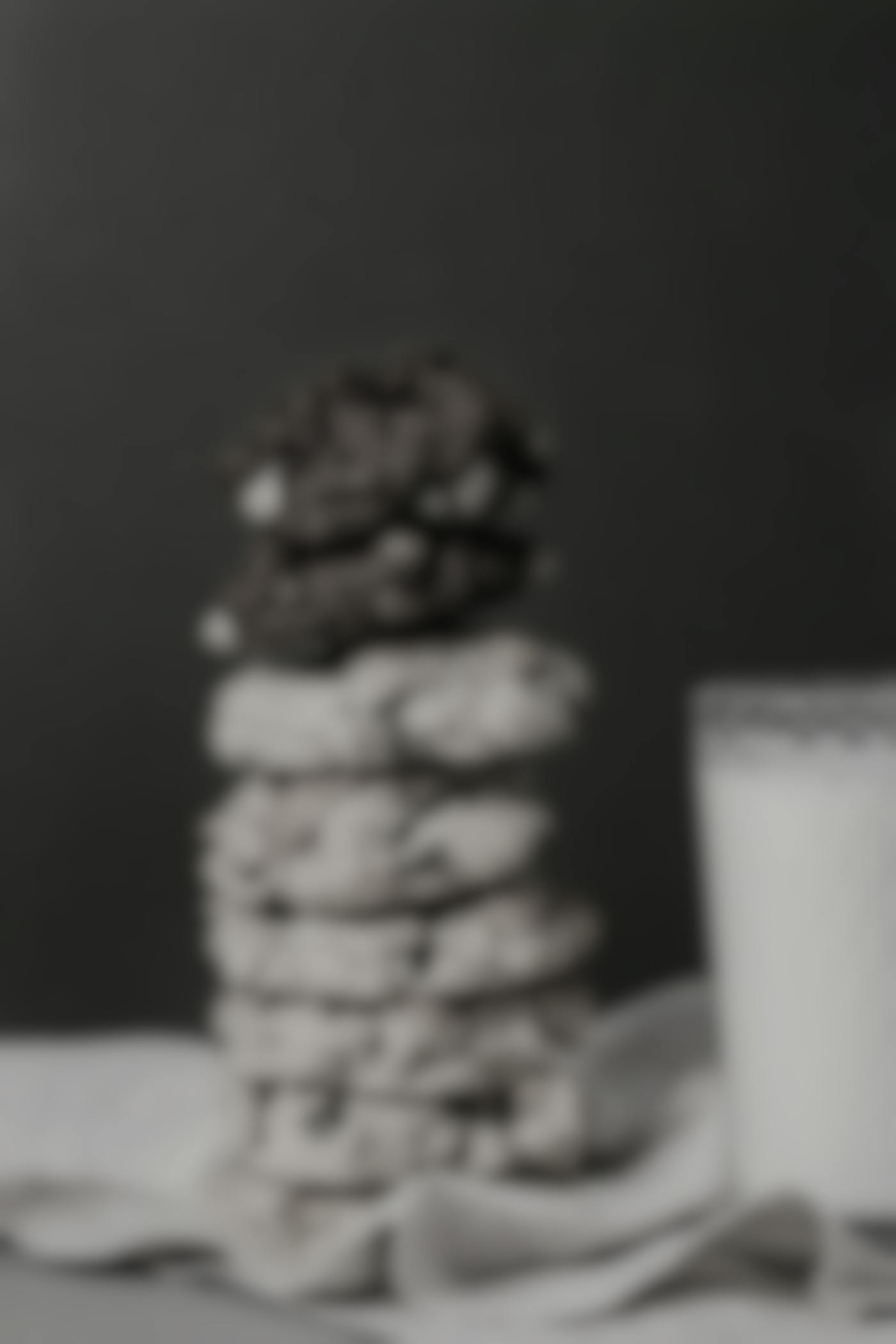 A stack of cookies next to a glass of milk