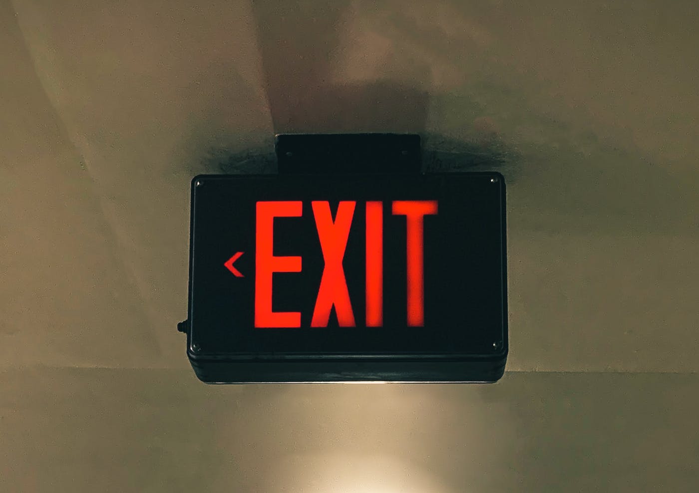 A red exit sign on the ceiling