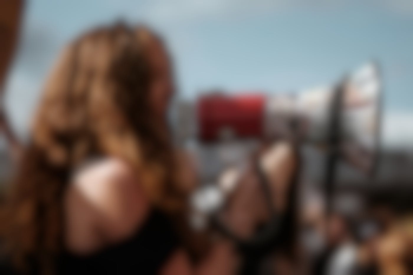 A woman at an outdoor rally using a bullhorn