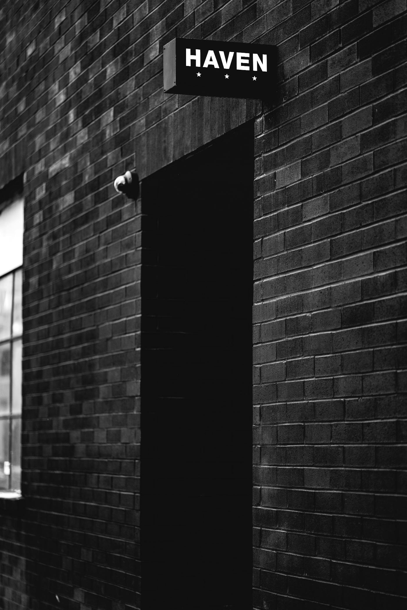 a dark door with a small sign reading Haven over it.