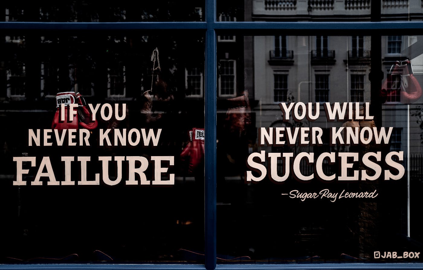Fromnt windows of a boxing gym with the Sugar Ray Leonard quote: "If you never know failure, you will never know success"