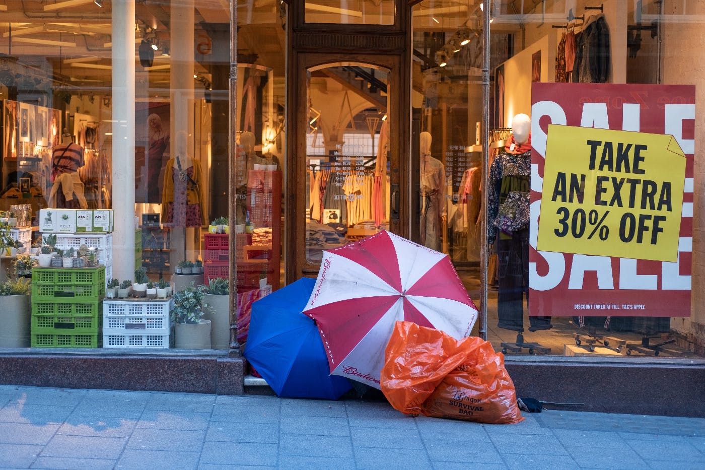 People camped out in front of a store advertising an extra 30% off