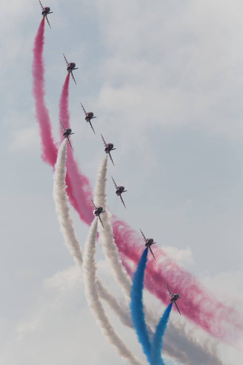 Blue Angels in formation with red, white and blue smoke