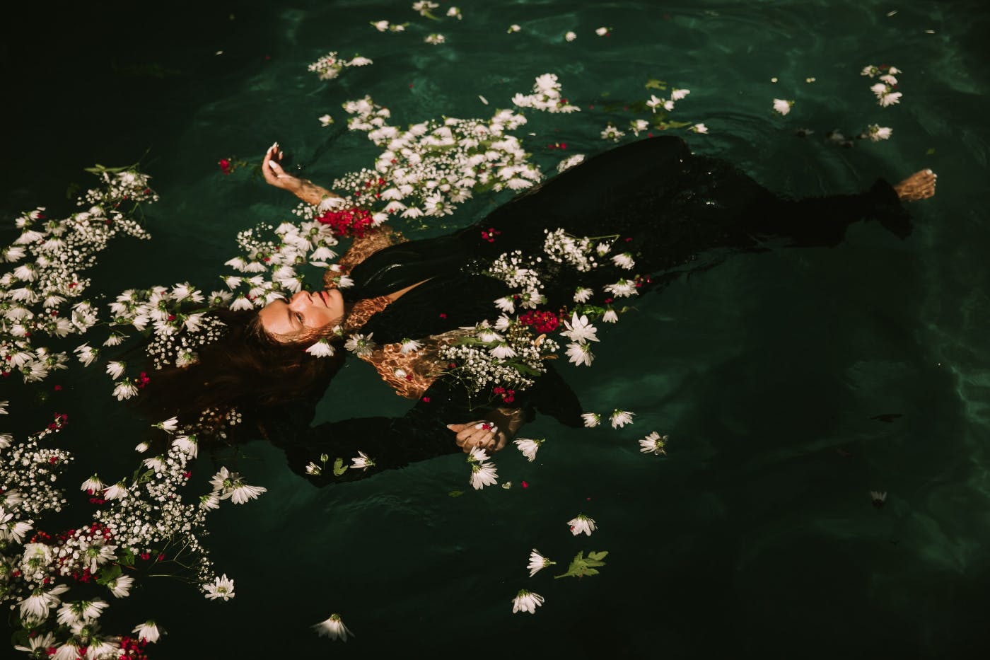 Ophelia floating in a pond with flowers