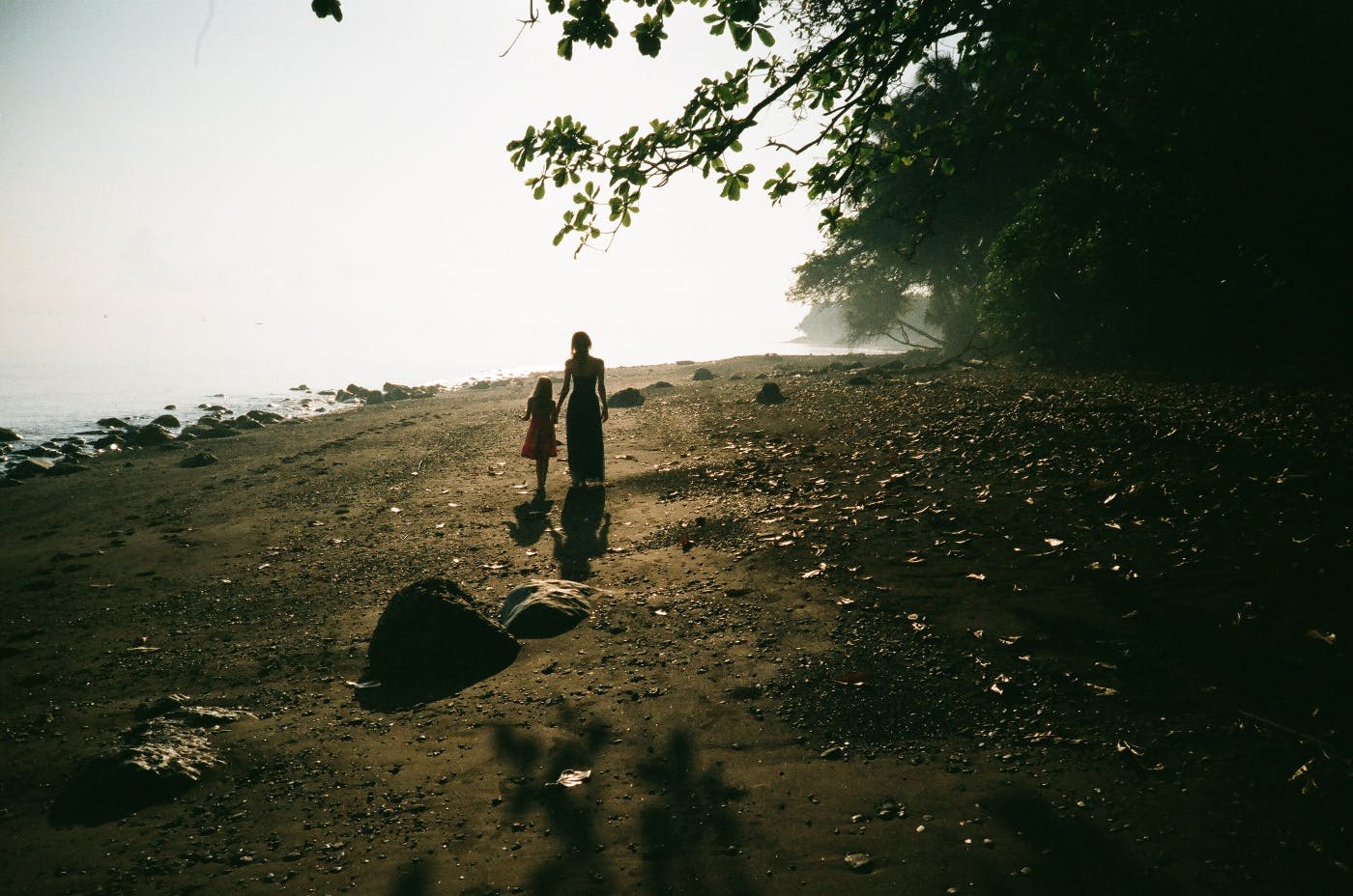 A mother walking by the water with her daughter