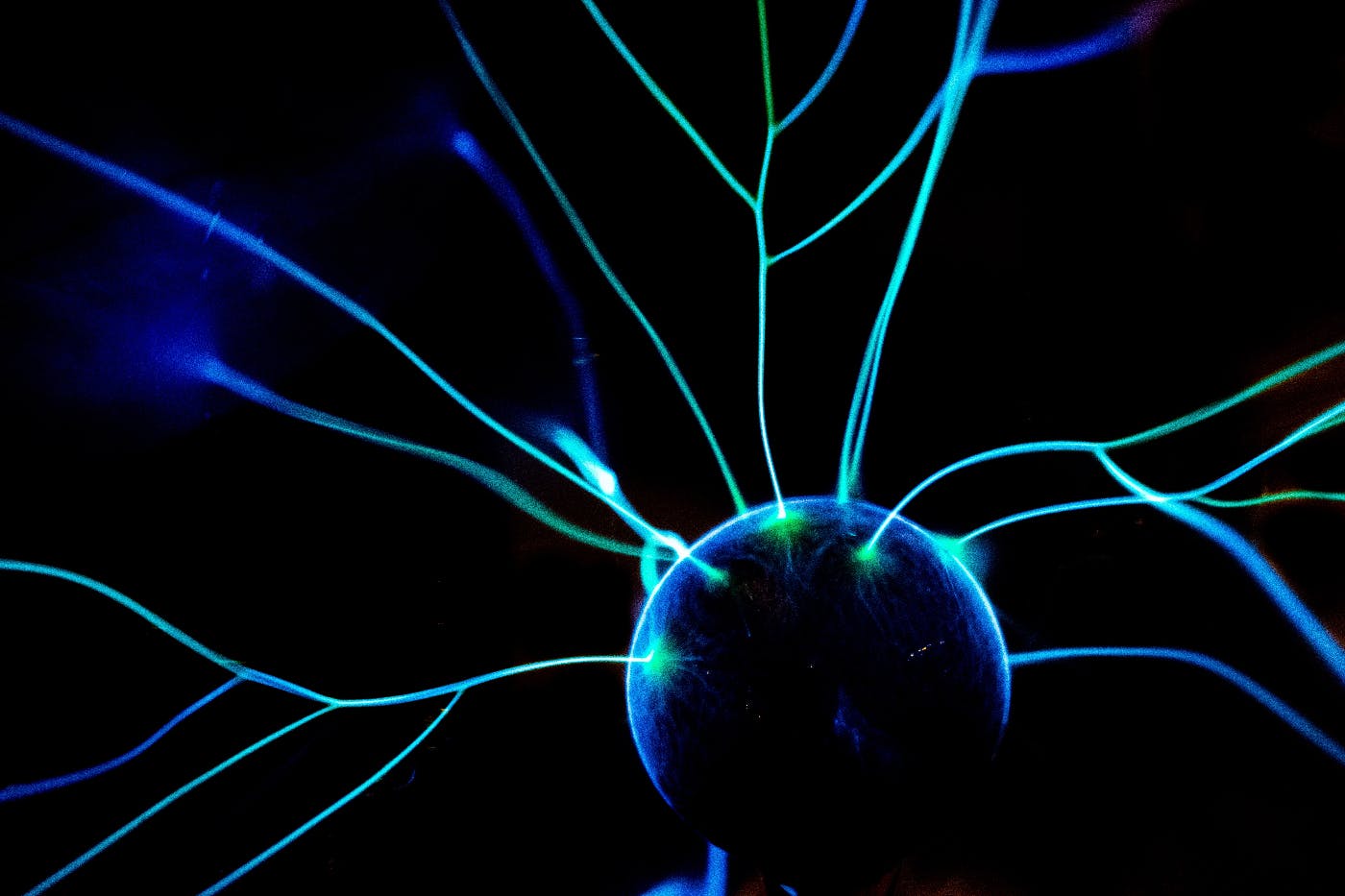 A plasma ball shooting green strands of electricity