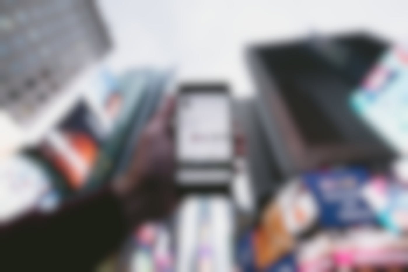a hand holding up a smartphone in the middle of Times Square