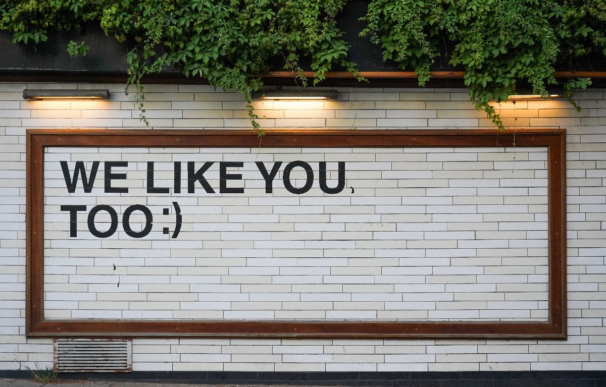 BIllboard with the words We Like You Too and :)