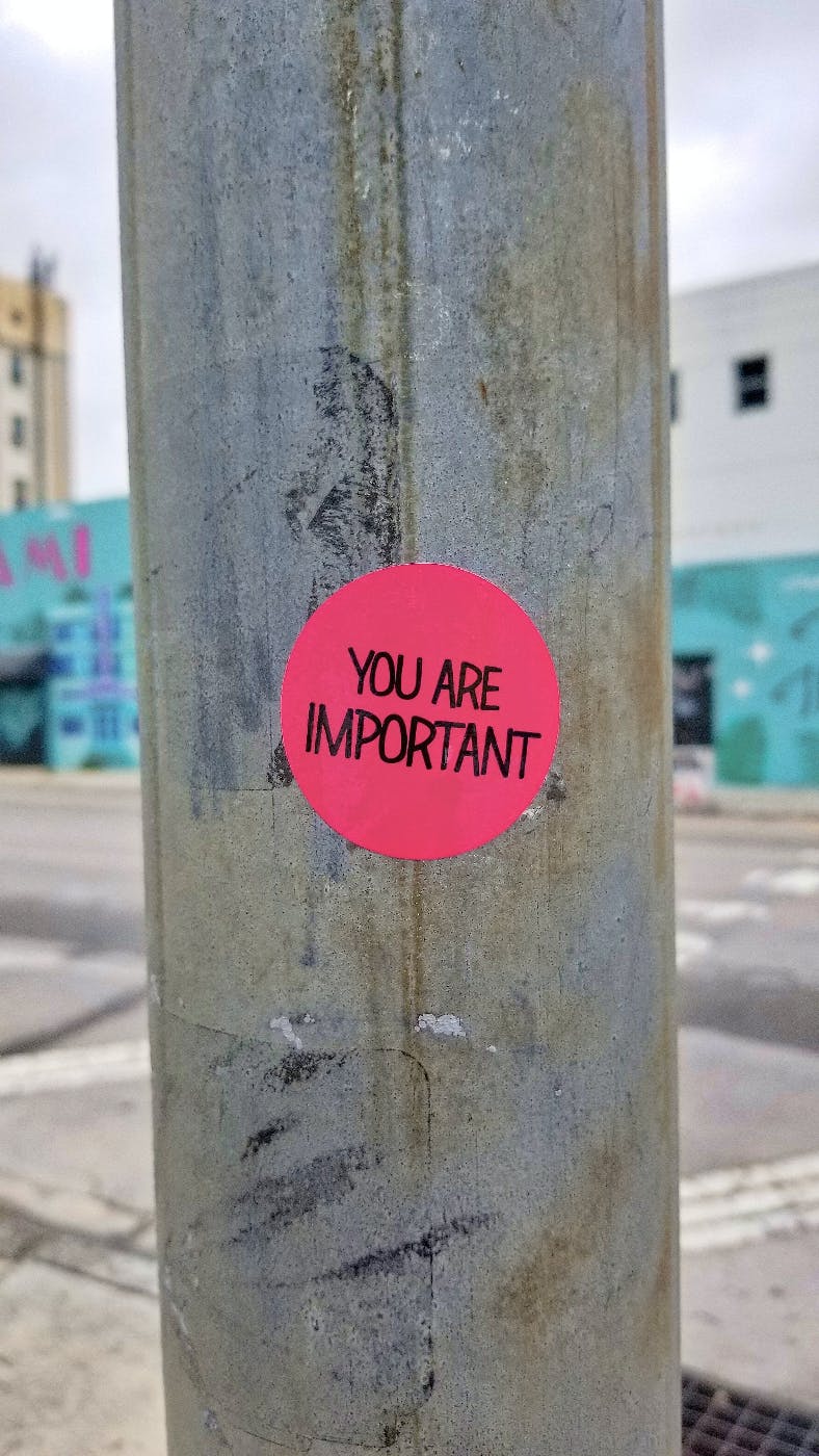 A phone pole with a red sticker reading: You Are Important