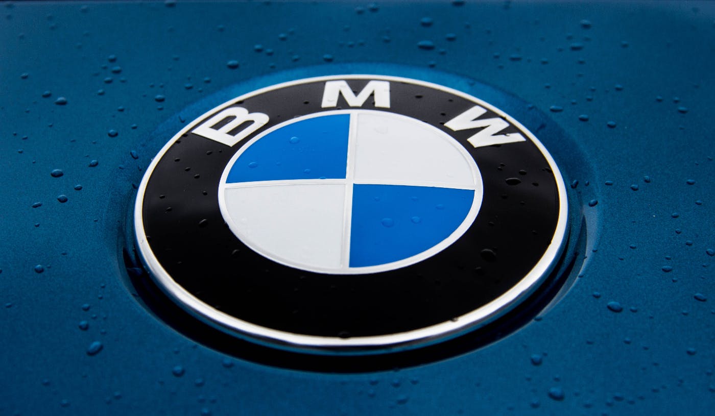 The BMW logo on the hood of a blue car