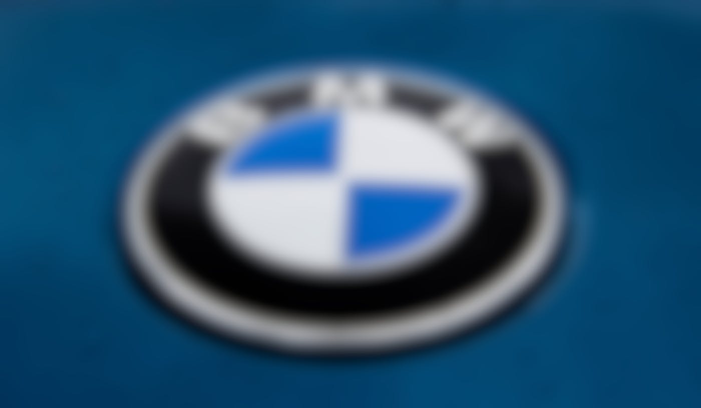 The BMW logo on the hood of a blue car
