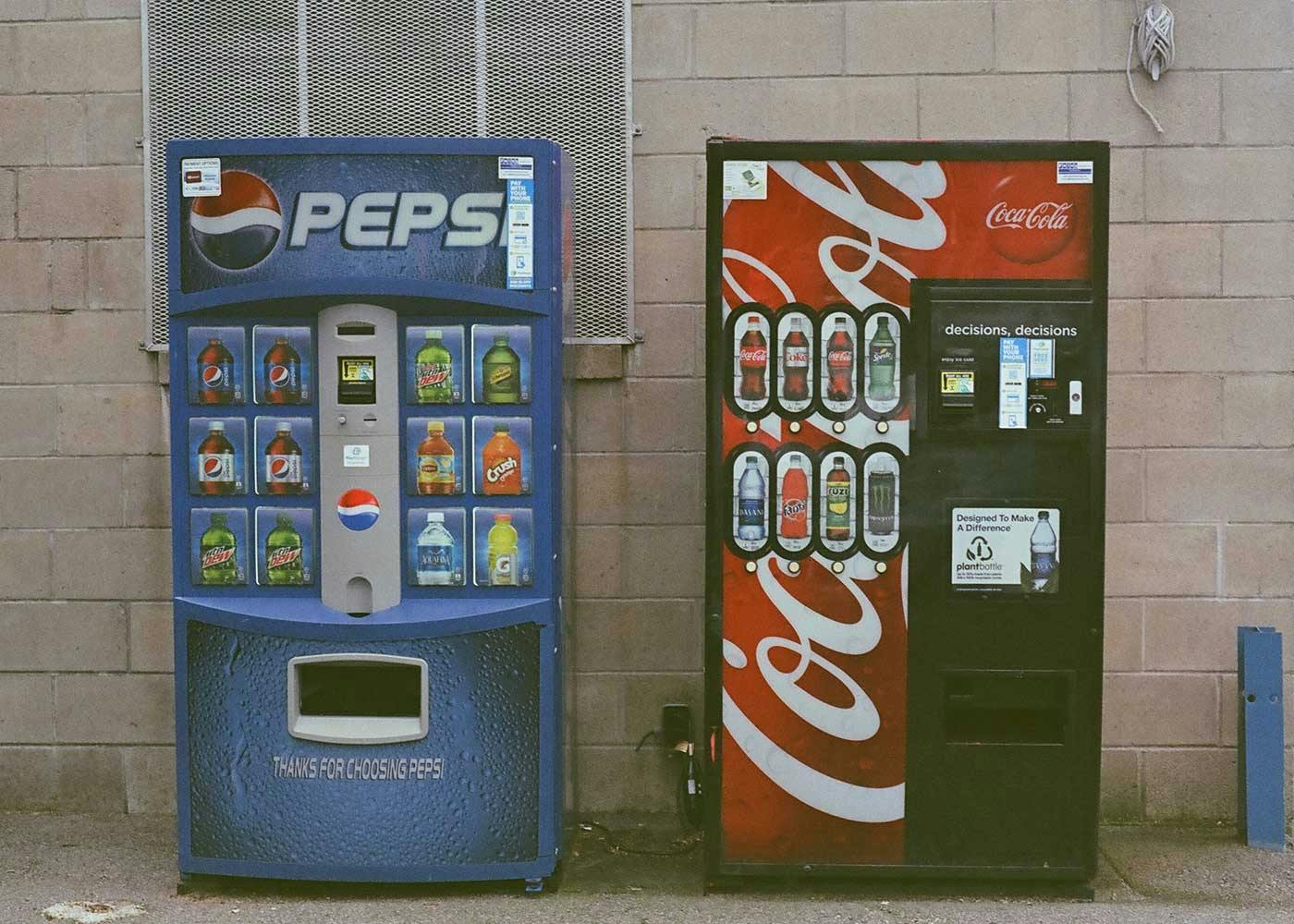 Pepsi machine next to a Coca Cola machine