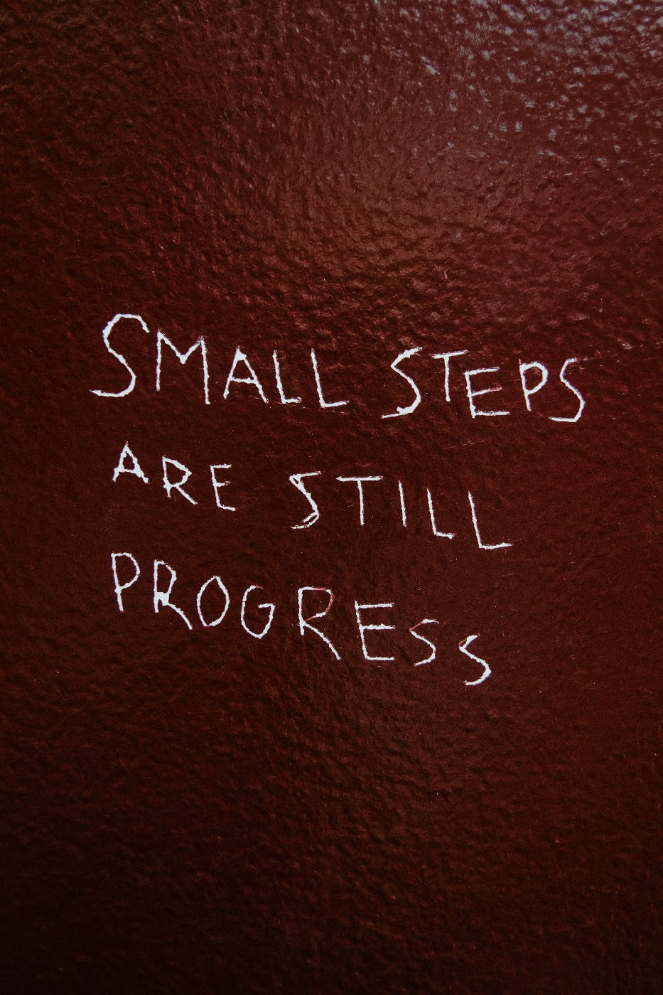 A wall with small steps are still progress scratched in it.