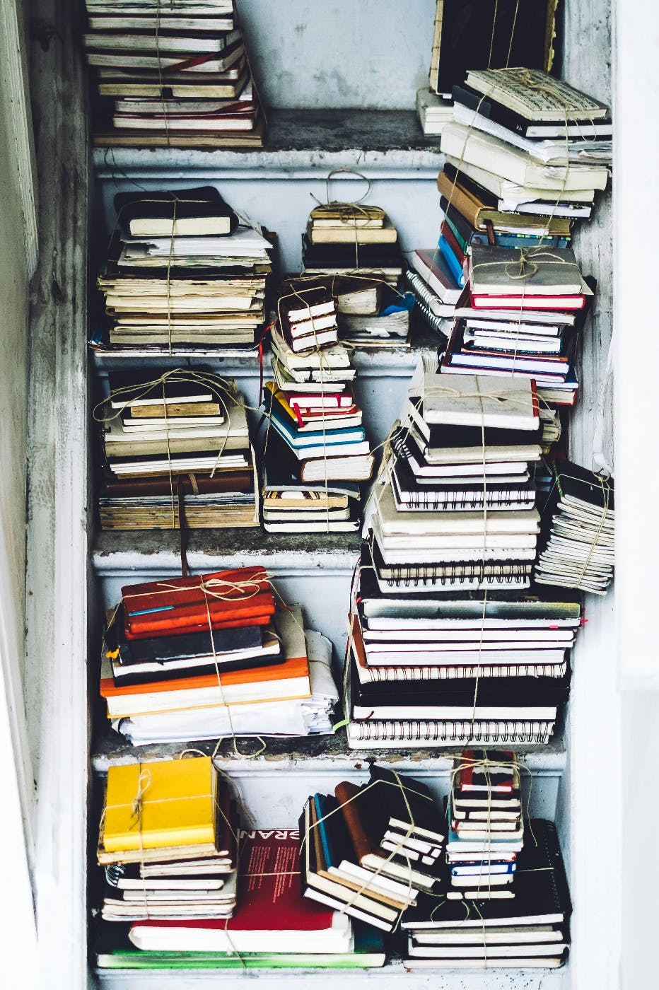 A closet full of journals tied in bundles