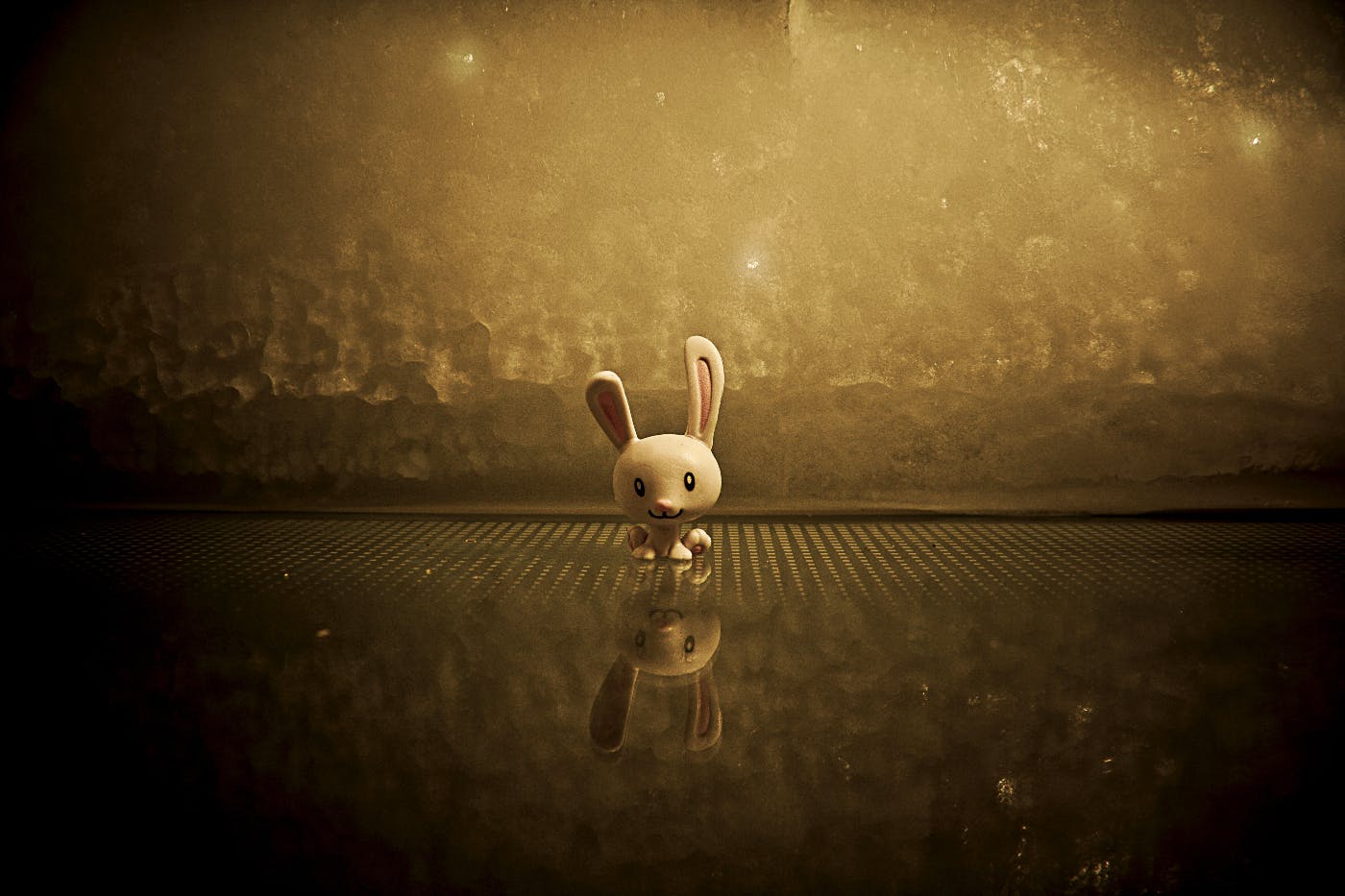 A small cartoon bunny in a sepia toned environment