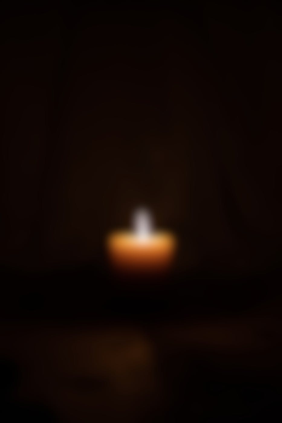 a single candle in a dark room