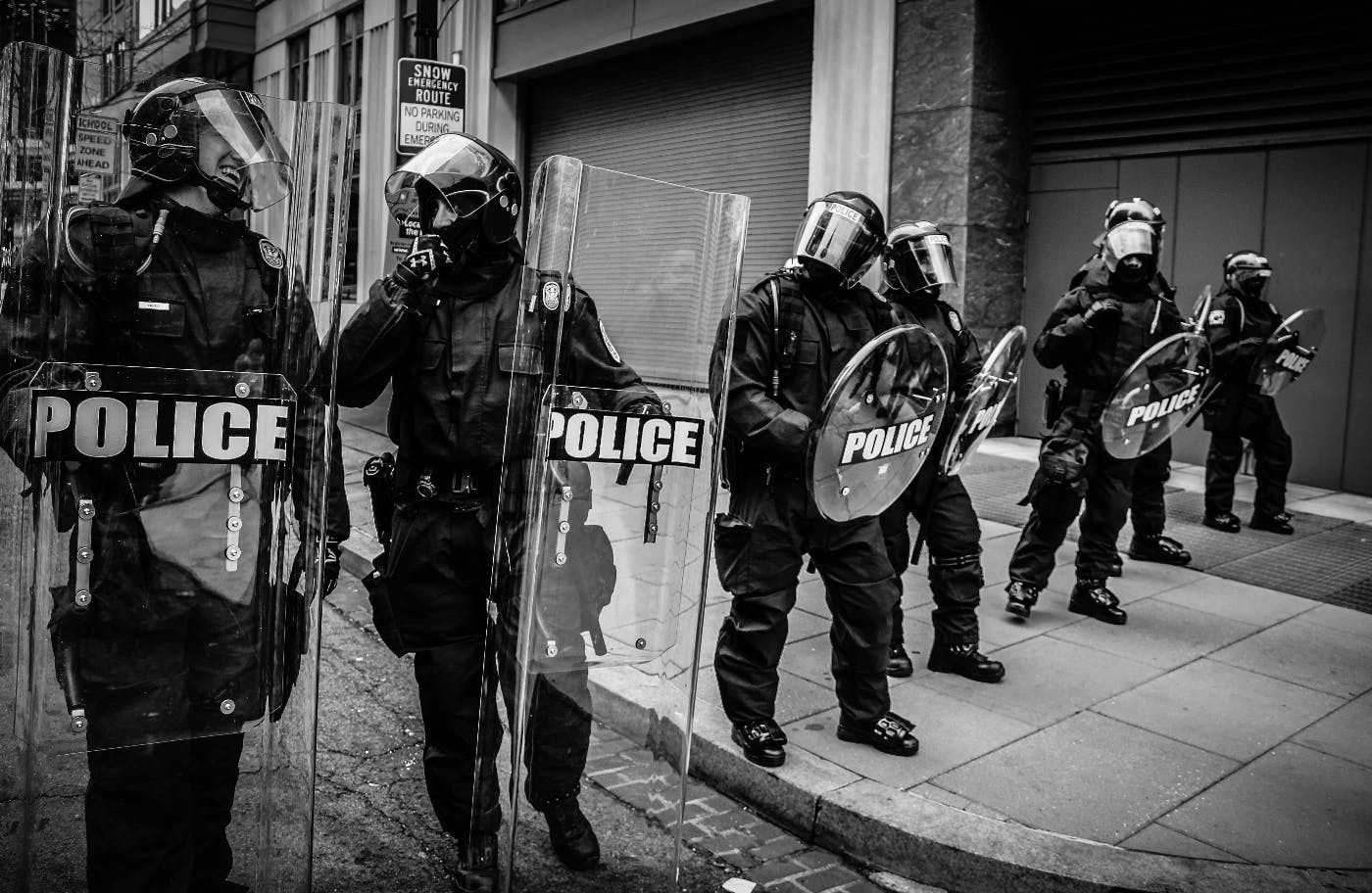 A line of police with shields and riot gear