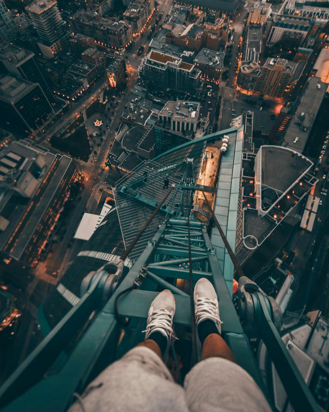 A person standing on a high tower looking down from the person's POV
