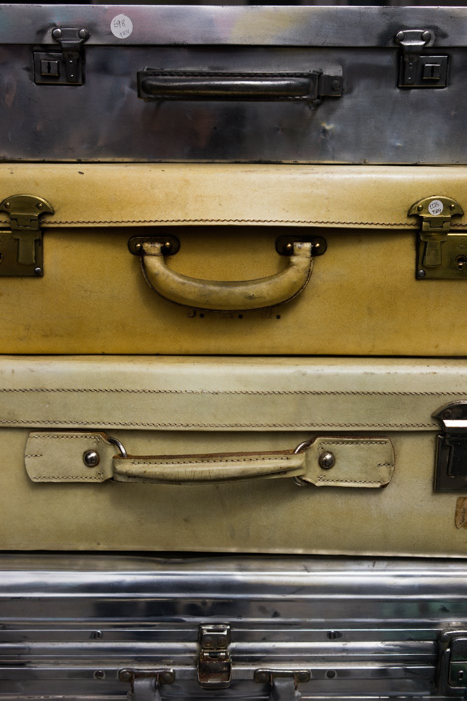 A stack of suitcases, handles facing the camera