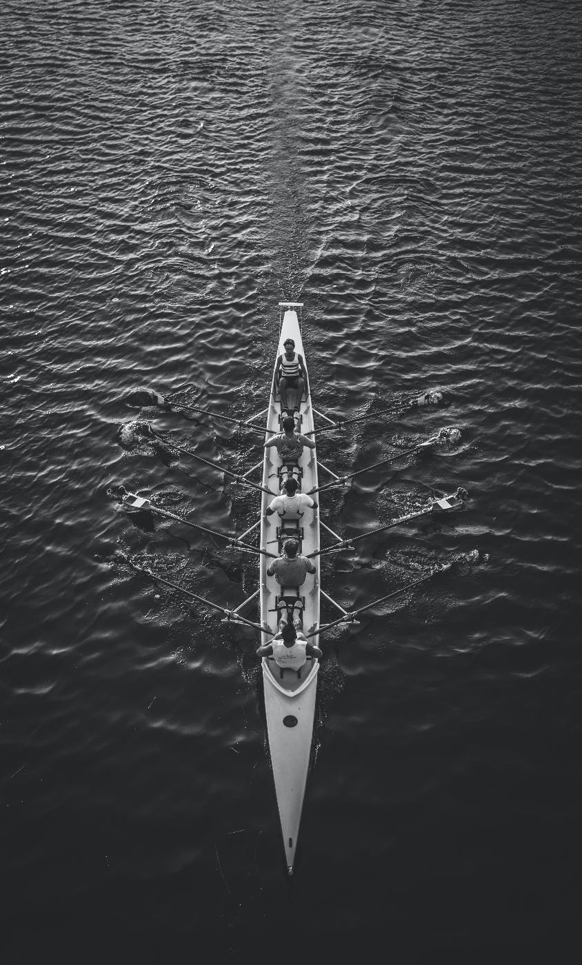 men in a skulling boat