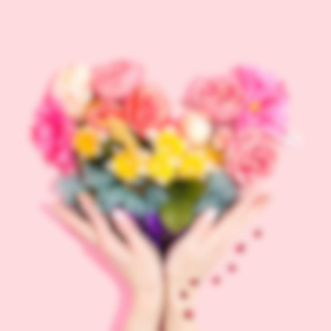 Two hands supporting a bouquet of flowers in a heart shape