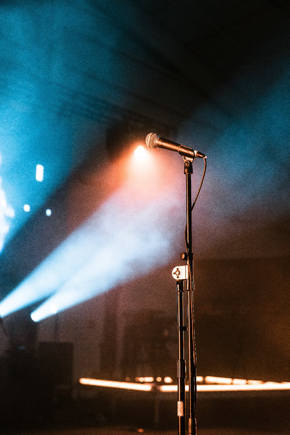 A mic on a stand in spotlights