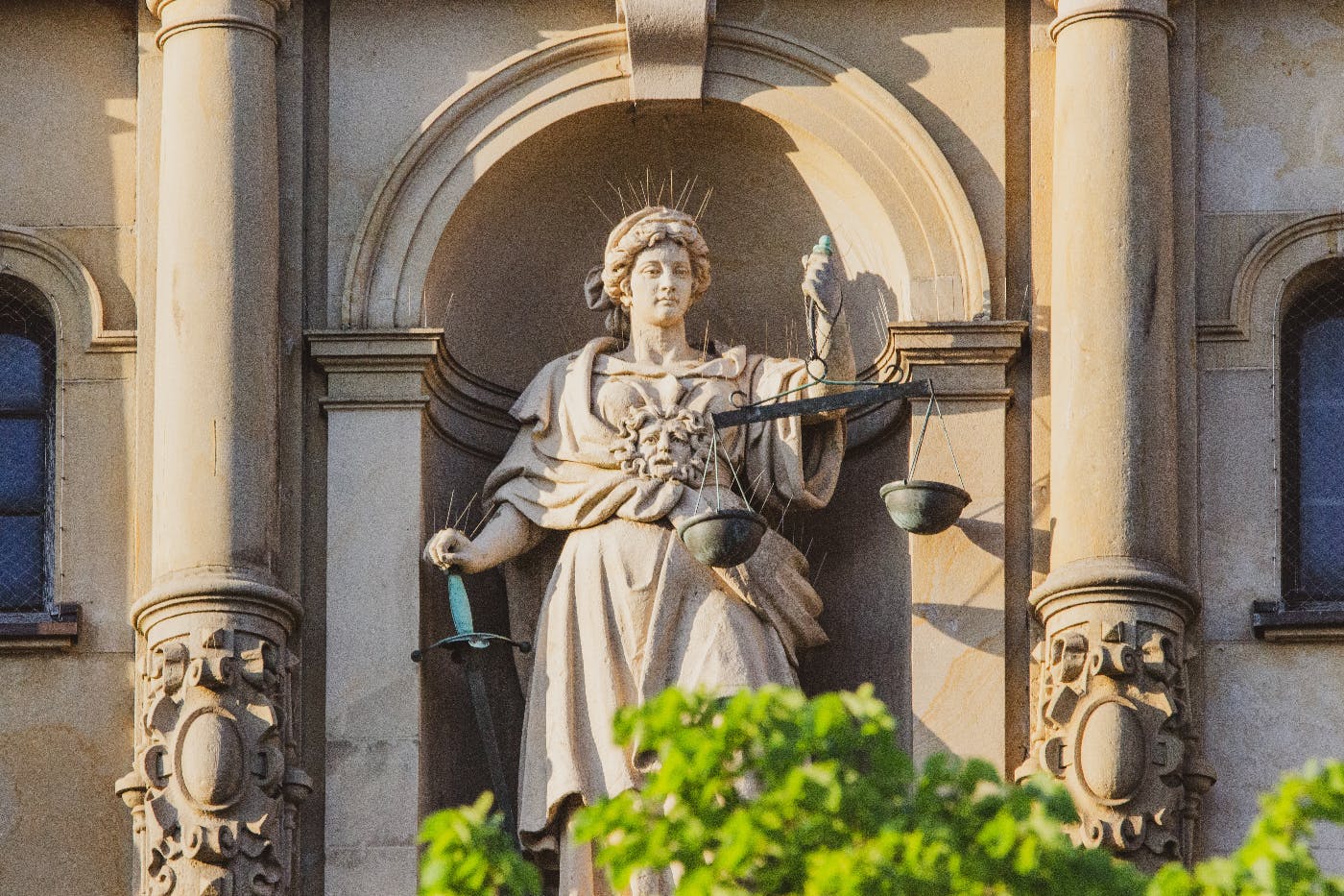 A statue of Lady Justice in a pillar framed alcove