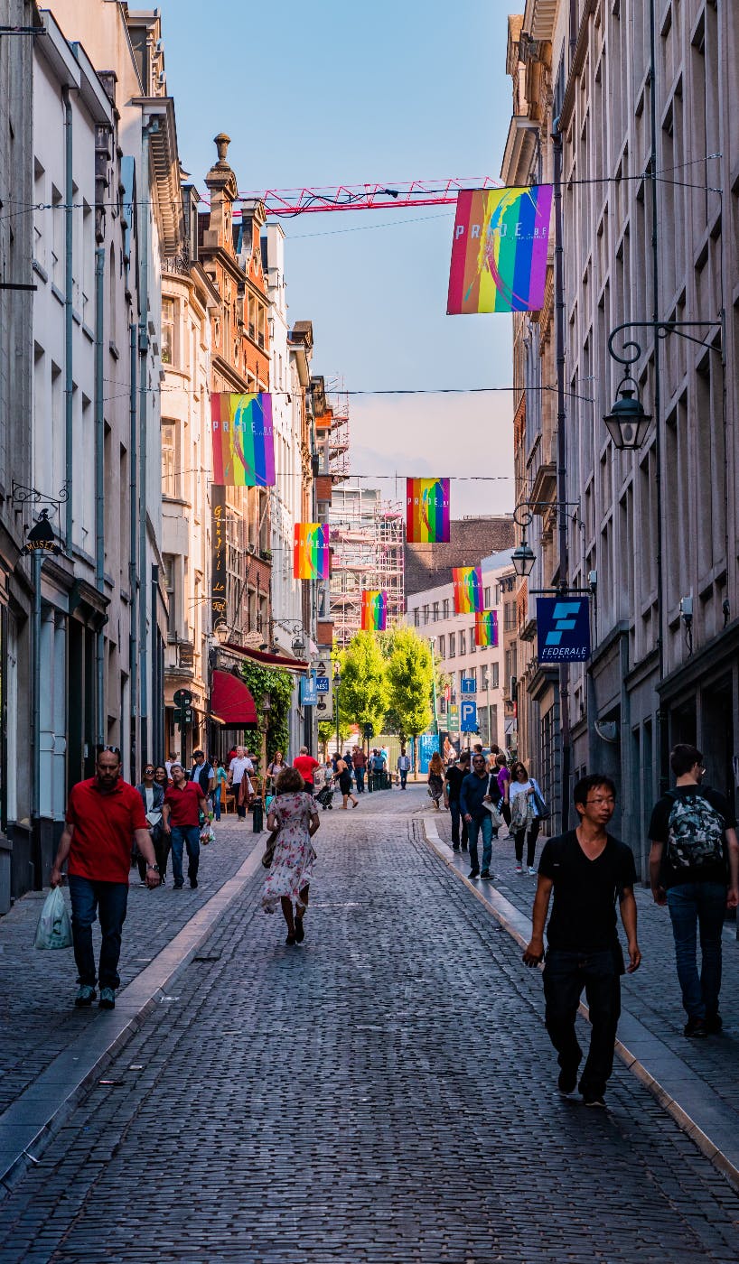 A street with many ranbow flags hanging from windows